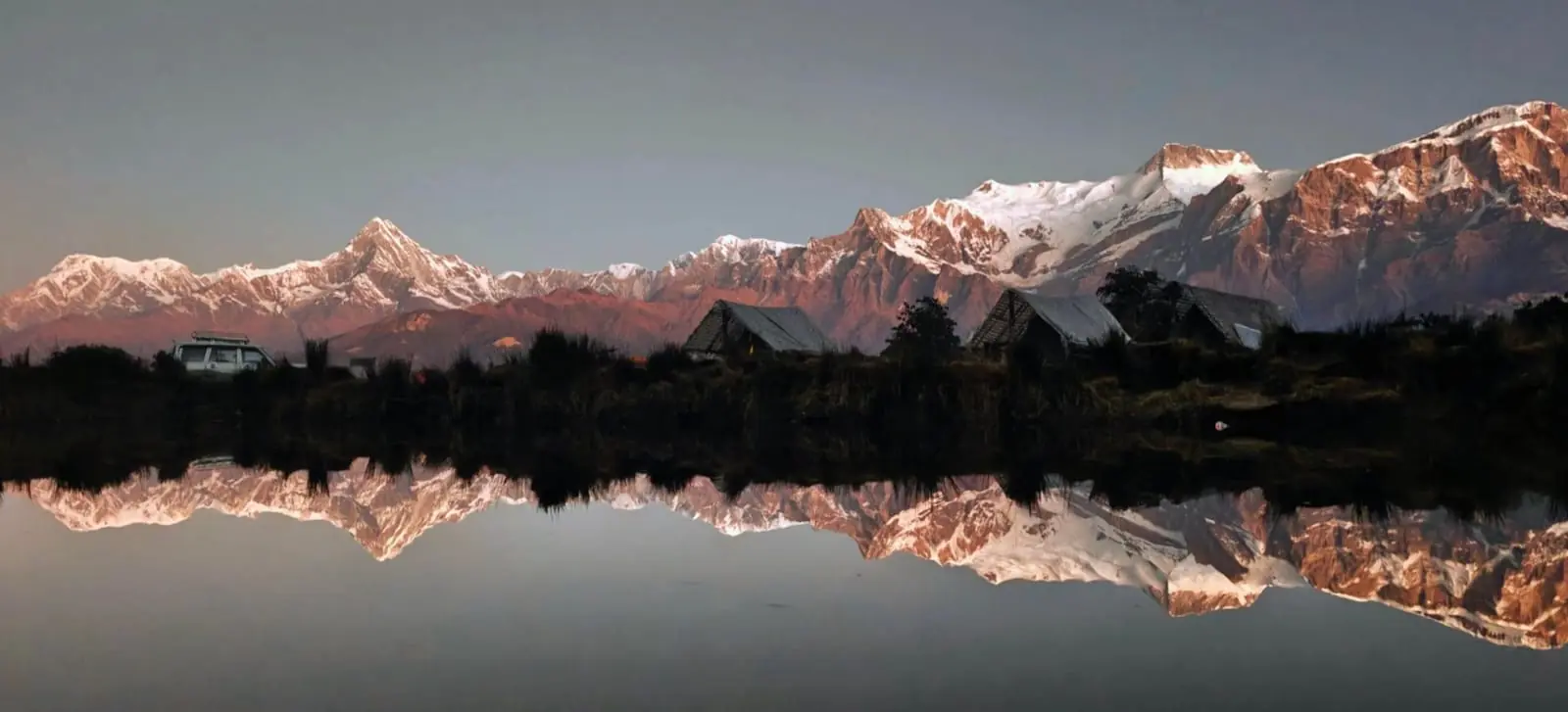 Snowy mountains reflected in a still lake